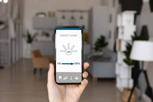 istock Close up of woman use smart home application on cell 1335085312