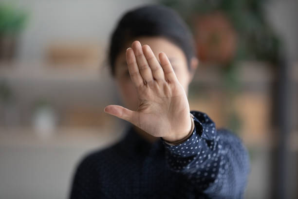 Young ethnic woman show stop hand gesture Close up of determined young Indian woman show stop no gesture protest against racial or gender discrimination. Serious ethnic biracial female make sign against abortion or domestic violence. objections stock pictures, royalty-free photos & images