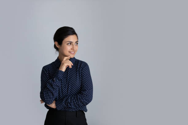 istock Smiling Indian woman look at empty copy space 1335085351