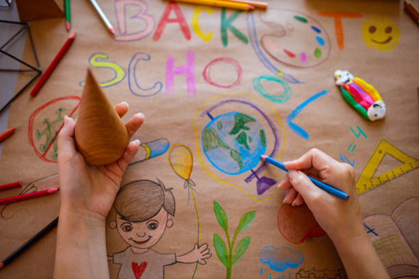 istock Dedicated and creative school teacher drawing a poster with the theme 