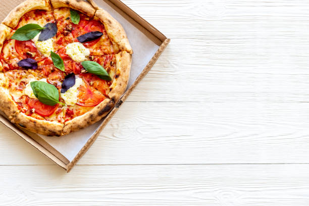 Delicious pizza with cheese tomatoes sauce and basil