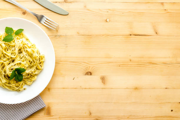 Plate of pasta fettuccine with cream sauce and herbs