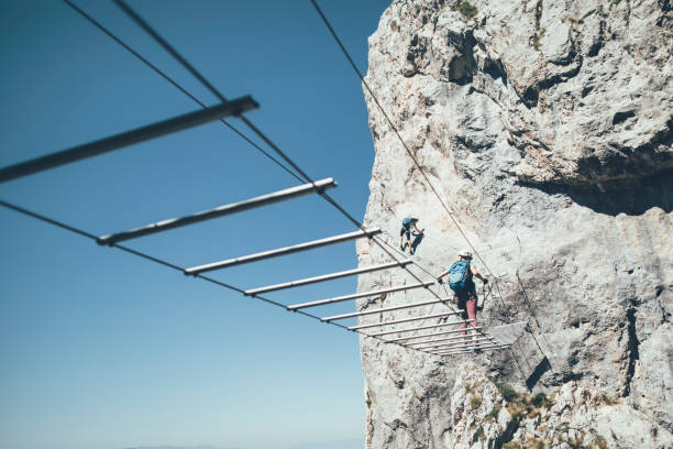 istock Climbers climbing via ferrata 1335095054