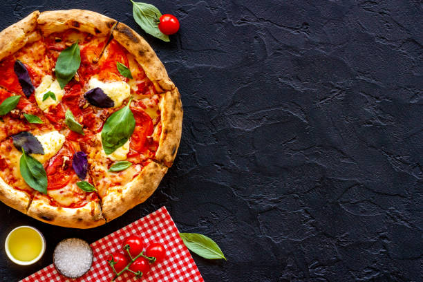 istock Italian pizza with tomatoes cheese and basil, top view 1335095512