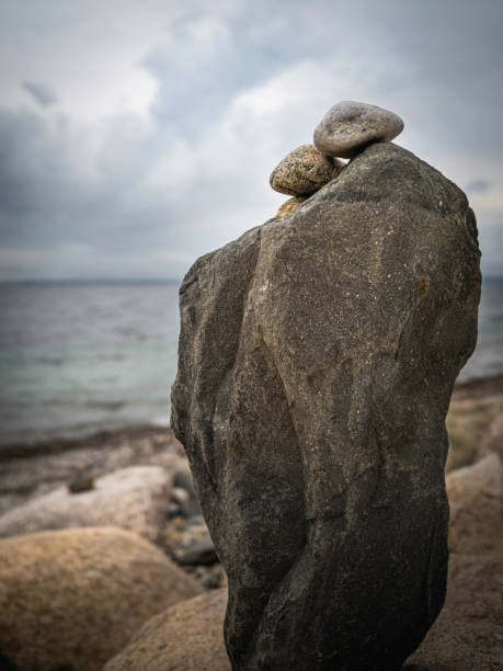 istock Anthropomorphic black rocks on the beach standing like two couples 1335095523