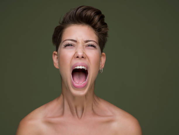 istock oung beautiful woman shouting with an angry expression 1335097565