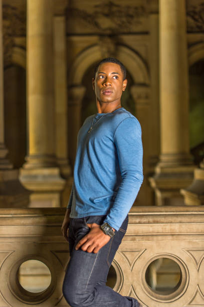 istock Portrait of Young Black College Student standing inside office building, looking forward 1335097711