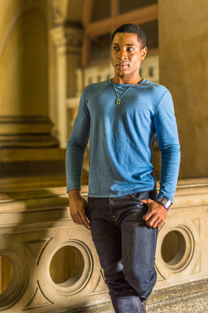 istock Portrait of Young Black College Student standing inside office building, looking forward 1335097712