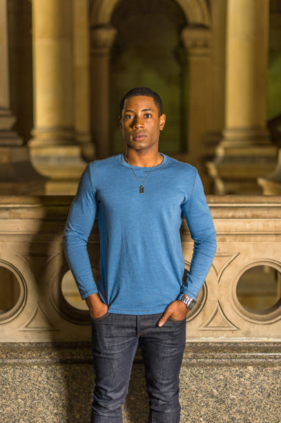 istock Portrait of Young Black College Student standing inside office building, looking forward 1335097713