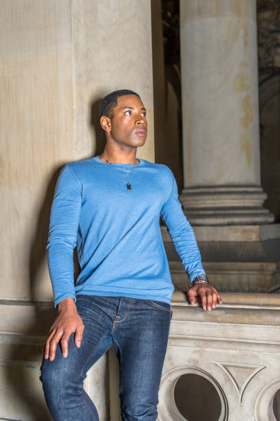 istock Portrait of Young Black College Student standing inside office building, looking forward 1335097746