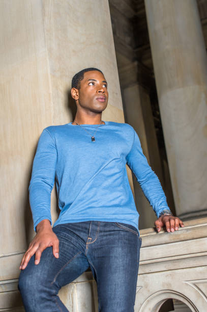 istock Portrait of Young Black College Student standing inside office building, looking forward 1335097772