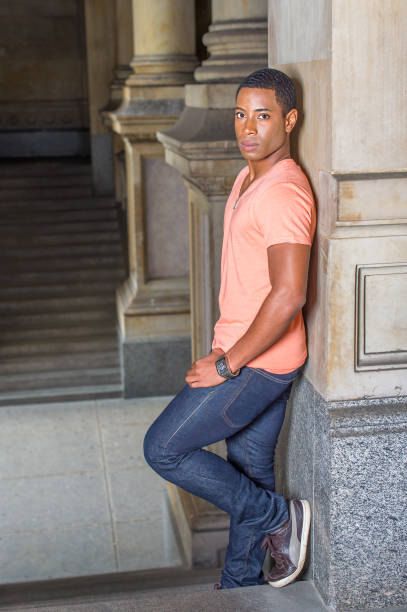 istock Young black man standing inside office building, relaxing 1335097976
