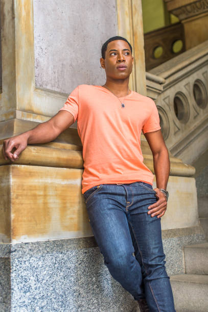 istock Portrait of Young Black College Student standing inside office building, looking forward 1335098014