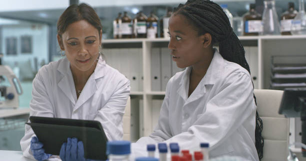istock Shot of two scientists using a digital tablet in a lab 1335098250