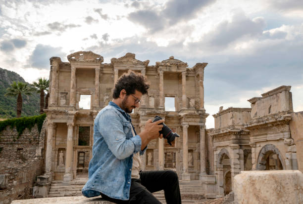 photographer taking pictures at ancient city of ephesus, izmir, turkey - turkey tourist ephesus roman imagens e fotografias de stock