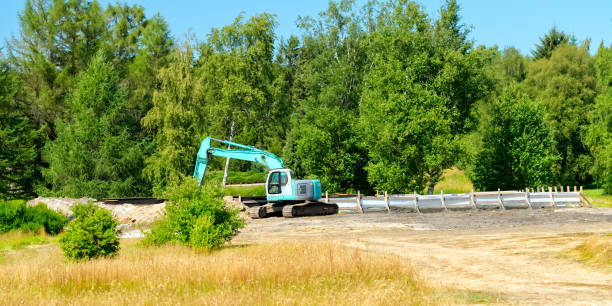 istock large excavator in the field in front of the forest 1335109100