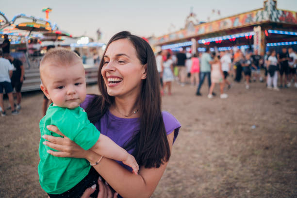istock Happy Boy and Mother on Carousel 1335110515