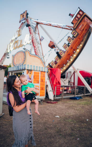 istock Happy Boy and Mother on Carousel 1335110721