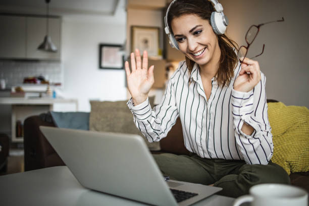 istock Young woman talking on a video call and smiling 1335110726