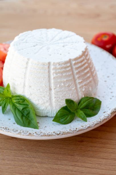 istock Cheese collection, white Italian soft cheese ricotta served with fresh tomatoes and basil 1335112910