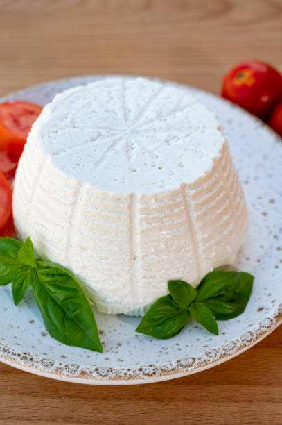 istock Cheese collection, white Italian soft cheese ricotta served with fresh tomatoes and basil 1335112912