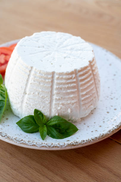 istock Cheese collection, white Italian soft cheese ricotta served with fresh tomatoes and basil 1335112915