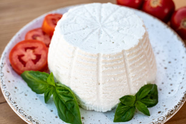 istock Cheese collection, white Italian soft cheese ricotta served with fresh tomatoes and basil 1335112919