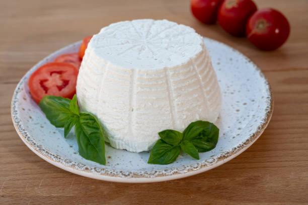 istock Cheese collection, white Italian soft cheese ricotta served with fresh tomatoes and basil 1335112921