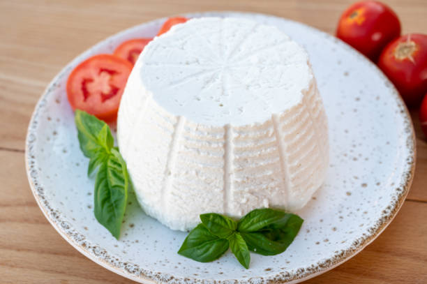 istock Cheese collection, white Italian soft cheese ricotta served with fresh tomatoes and basil 1335112922
