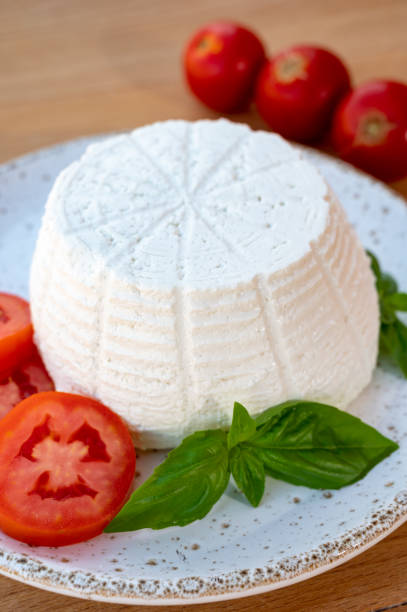 istock Cheese collection, white Italian soft cheese ricotta served with fresh tomatoes and basil 1335112925