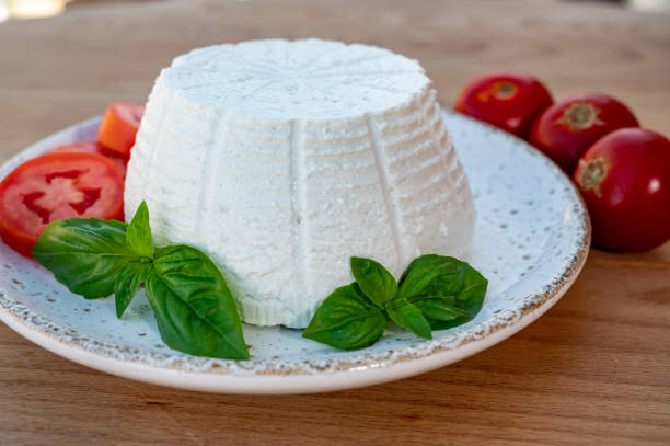 istock Cheese collection, white Italian soft cheese ricotta served with fresh tomatoes and basil 1335113001