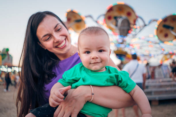 istock Happy Boy and Mother on Carousel 1335113046