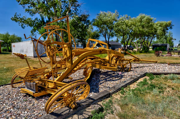 Three rusty steel framed farm land rollers ready for the ground maintenance on the meadows. Photograph taken near Unterbrunn, Bavaria.