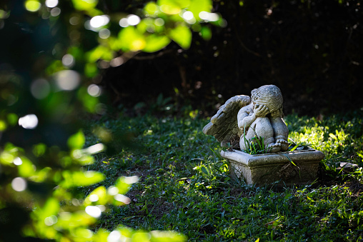 Cherub hiding its face from seeing something scary, Myrtles Plantation, St. Francisille, Louisiana, USA