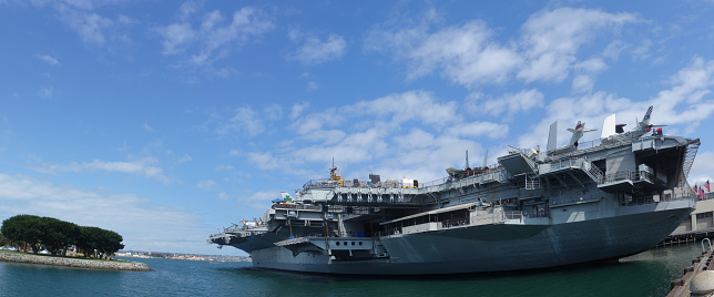 San Diego, CA -  August 19: Unites States aircraft carrier Midway aft (stern) and port side as seen from Harbor drive in San Diego Bay continuing its service as museum at present time