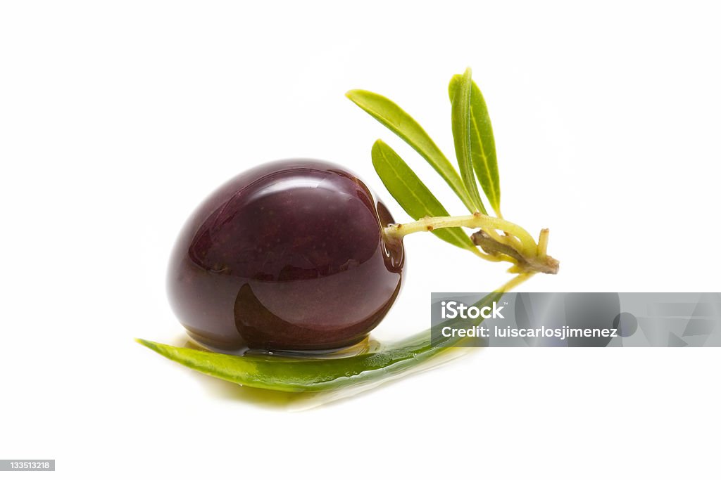 macro of olive macro of a fresh olives bathed in olive oil on white background Branch - Plant Part Stock Photo