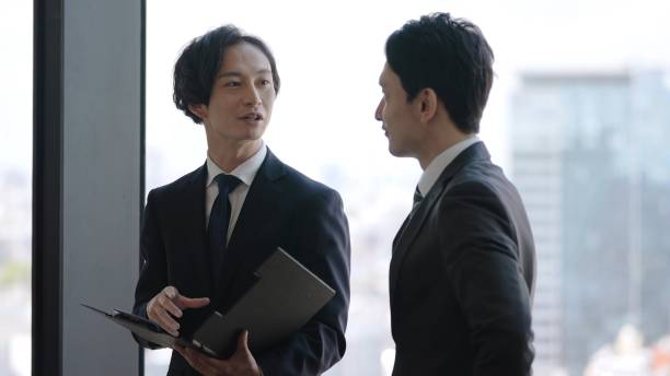 istock asian businessmen talking in the office 1335142469