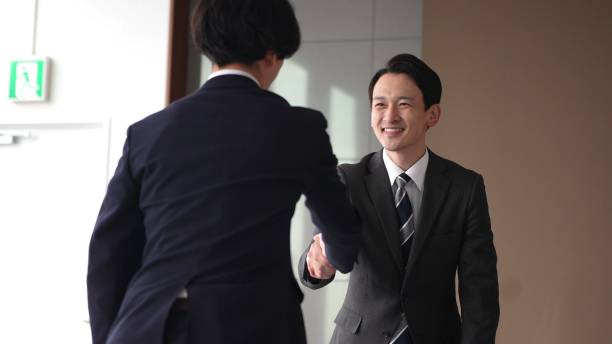 istock asian businessmem shaking hands 1335142470