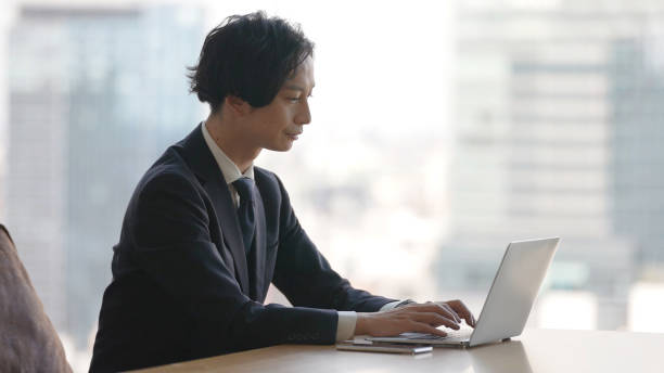 istock asian business man using laptop in the office 1335142511