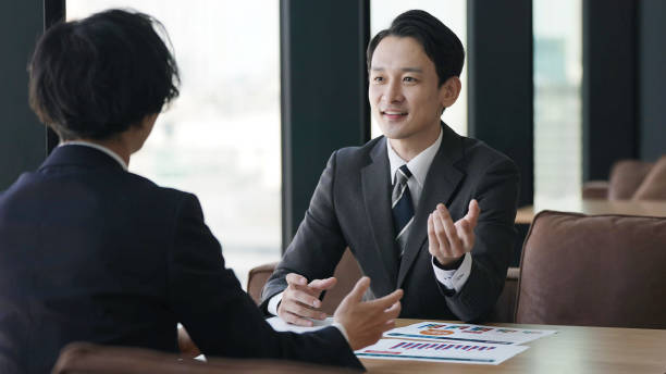 istock asian businessmen talking in the office 1335142521