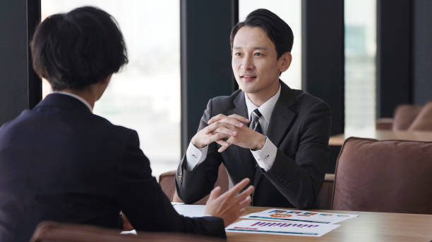 istock asian businessmen talking in the office 1335142523