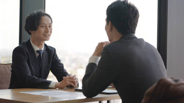 istock asian businessmen talking in the office 1335142528