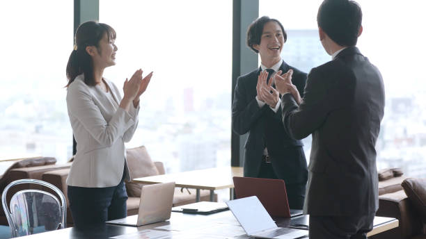 istock asian business group claping hands in the office 1335142544