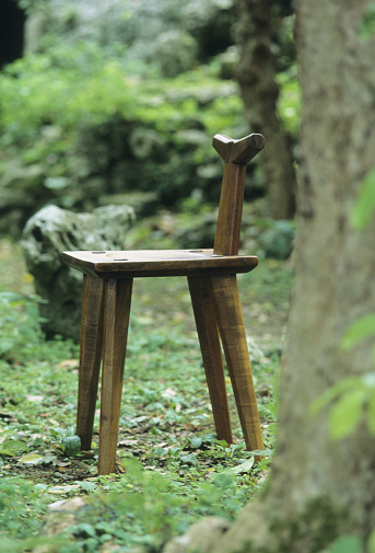 The wooden chairs placed outdoors in nature are perfect for a relaxation image.