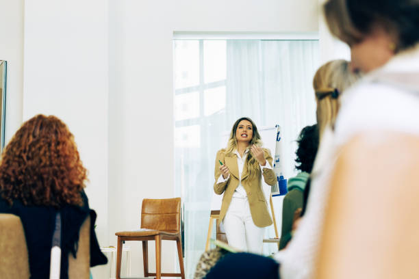 istock A woman performs training and in her hand is a pen while other women watch attentively 1335152886