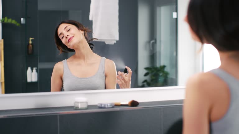 Woman using perfume