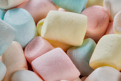 High angle extreme close-up background of an assortment of colorful marshmallows