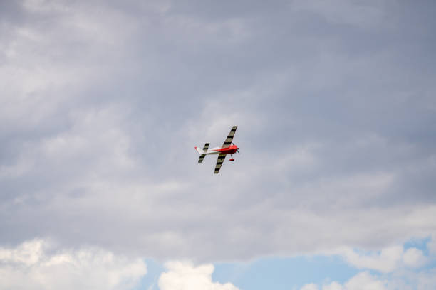 RC propeller aircraft flying on a cloudy sky