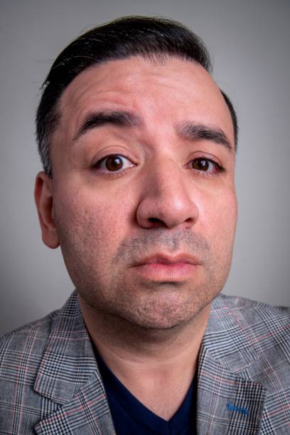 istock Serious arrogant mature man looking at the camera on gray background 1335159157