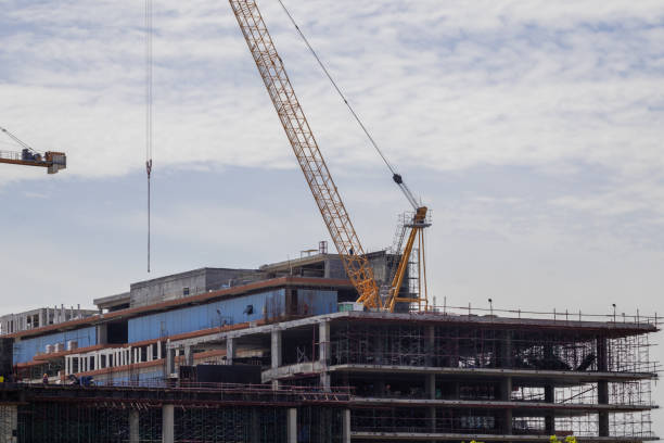istock Hight rising crane working on construction site building hight tower condominium with blue sky background 1335162187